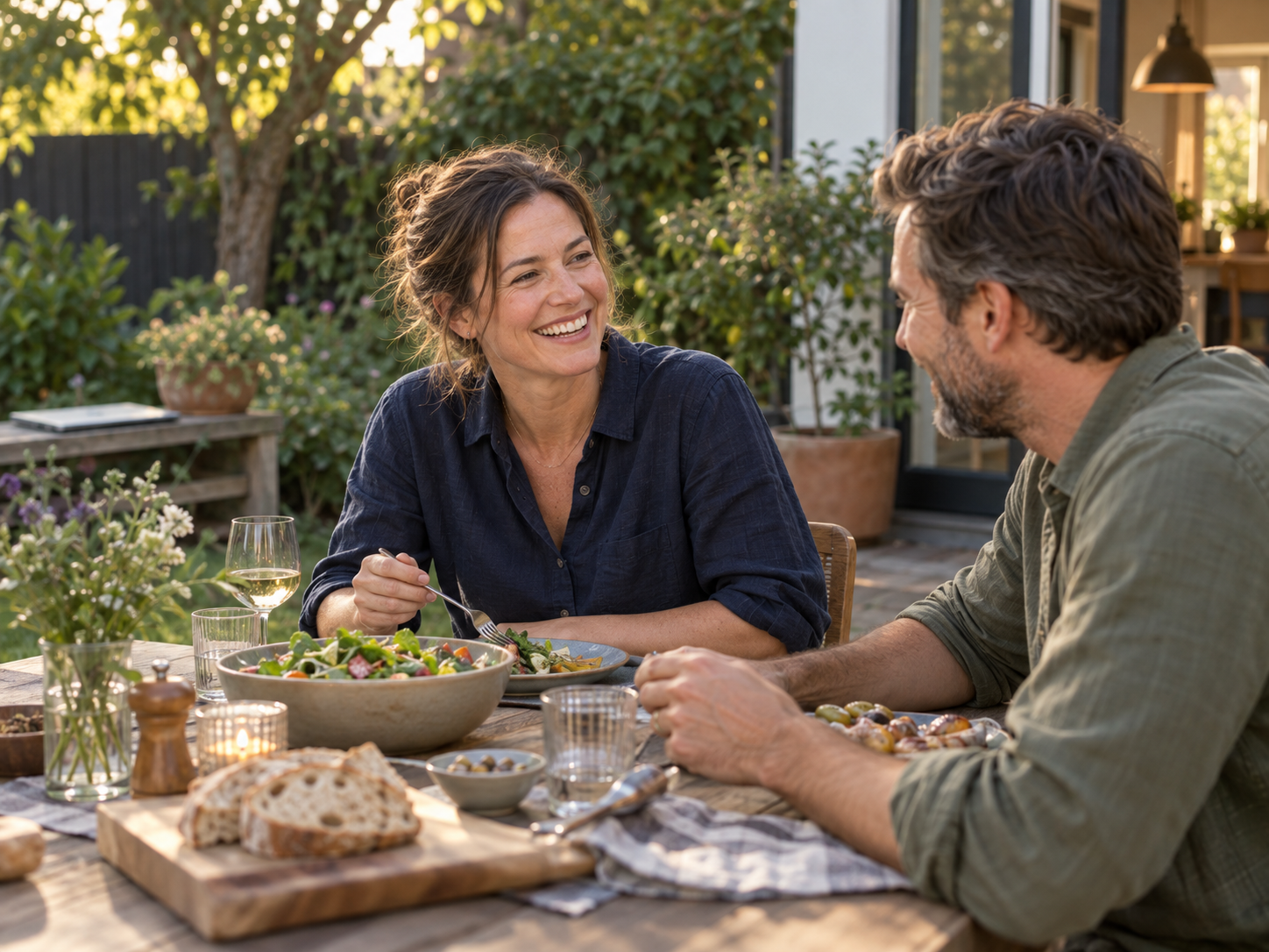 An owner enjoying an evening meal with her partner in the garden